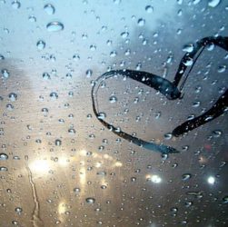 ventana empañada de lluvia y un corazón dibujado